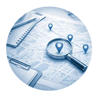 A magnifying glass over a map with location pins